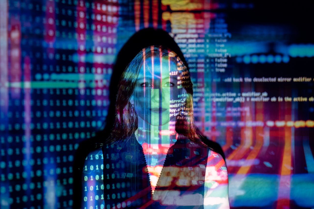 Services-03 A woman with digital code projections on her face, representing technology and future concepts.